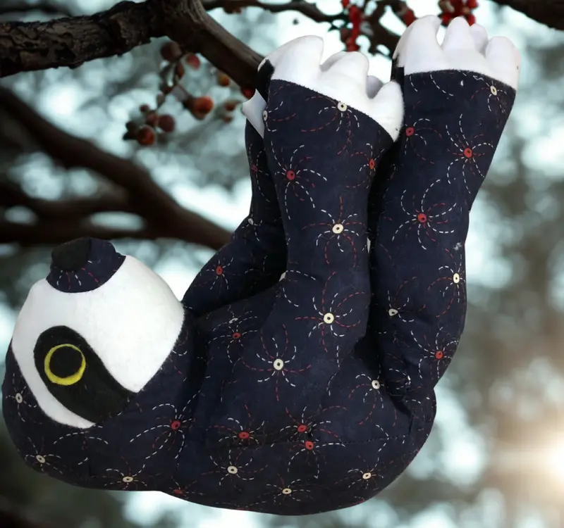 Handmade sloth hanging from a tree