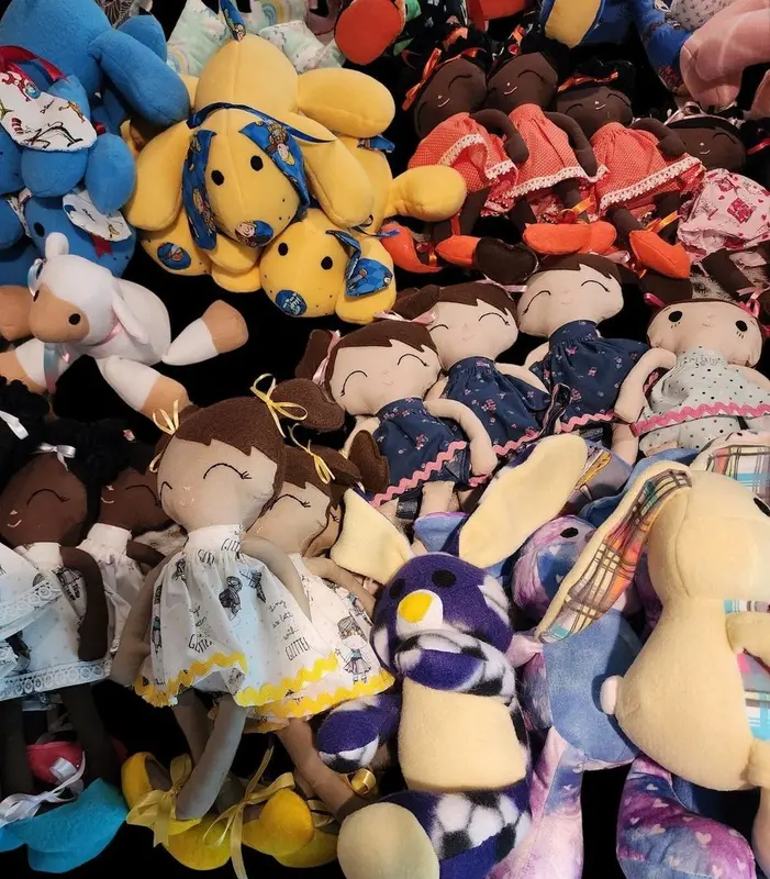 A pile of handmade dolls and stuffed animals
